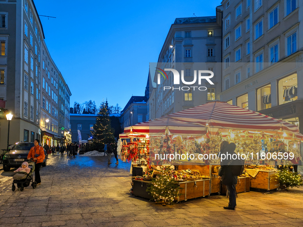 People enjoy the pre-Christmas atmosphere in the old town of Salzburg, Austria, on December 7, 2023. 