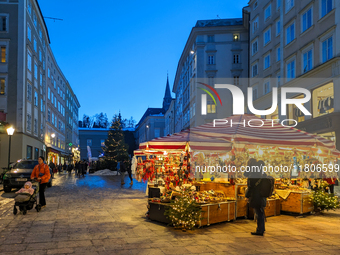 People enjoy the pre-Christmas atmosphere in the old town of Salzburg, Austria, on December 7, 2023. (