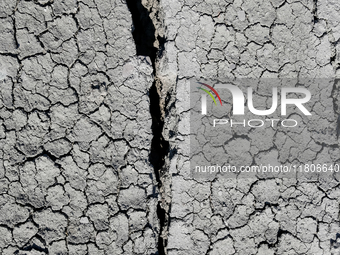 An austere, harsh landscape of dry mud left on mud volcano in Gobustan region near Baku, Azerbaijan on November 24, 2024. (