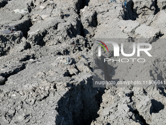 An austere, harsh landscape of dry mud left on mud volcano in Gobustan region near Baku, Azerbaijan on November 24, 2024. (