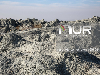 An austere, harsh landscape of dry mud left on mud volcano in Gobustan region near Baku, Azerbaijan on November 24, 2024. (