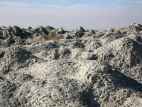 An austere, harsh landscape of dry mud left on mud volcano in Gobustan region near Baku, Azerbaijan on November 24, 2024. (