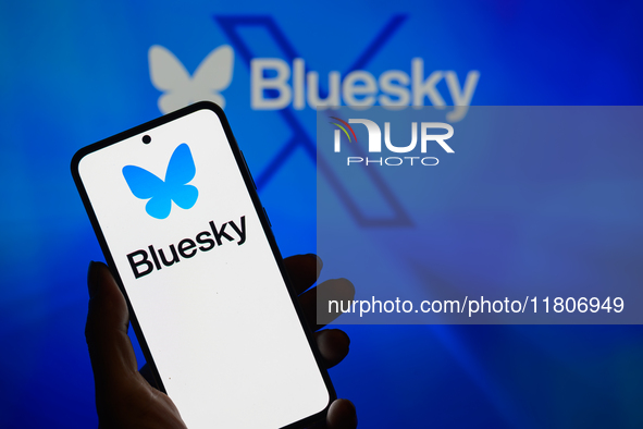 The Bluesky logo appears on a smartphone with Bluesky visible in the background in this photo illustration in Brussels, Belgium, on November...