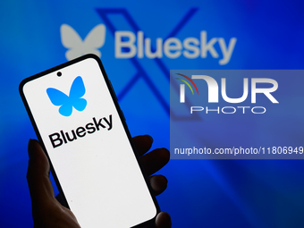 The Bluesky logo appears on a smartphone with Bluesky visible in the background in this photo illustration in Brussels, Belgium, on November...