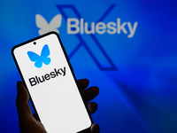 The Bluesky logo appears on a smartphone with Bluesky visible in the background in this photo illustration in Brussels, Belgium, on November...