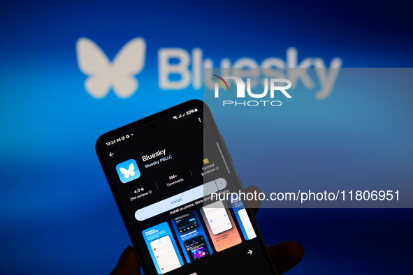 The Bluesky app logo appears on a smartphone with Bluesky visible in the background in this photo illustration in Brussels, Belgium, on Nove...