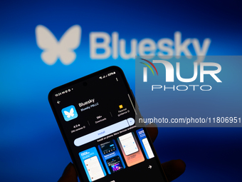 The Bluesky app logo appears on a smartphone with Bluesky visible in the background in this photo illustration in Brussels, Belgium, on Nove...