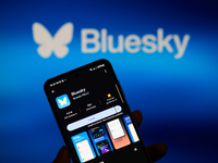 The Bluesky app logo appears on a smartphone with Bluesky visible in the background in this photo illustration in Brussels, Belgium, on Nove...