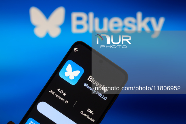 The Bluesky app logo appears on a smartphone with Bluesky visible in the background in this photo illustration in Brussels, Belgium, on Nove...