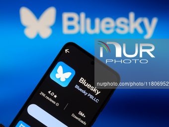 The Bluesky app logo appears on a smartphone with Bluesky visible in the background in this photo illustration in Brussels, Belgium, on Nove...