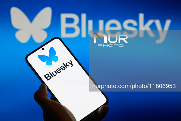 The Bluesky logo appears on a smartphone with Bluesky visible in the background in this photo illustration in Brussels, Belgium, on November...