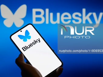 The Bluesky logo appears on a smartphone with Bluesky visible in the background in this photo illustration in Brussels, Belgium, on November...