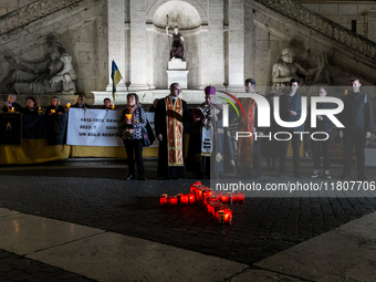 Ukrainian citizens participate in a torchlight procession in Capitol Square to commemorate the victims of the Holodomor 1932-1933, symbolizi...