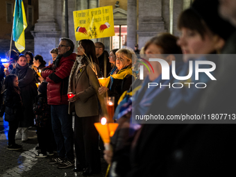 Ukrainian citizens participate in a torchlight procession in Capitol Square to commemorate the victims of the Holodomor 1932-1933, symbolizi...