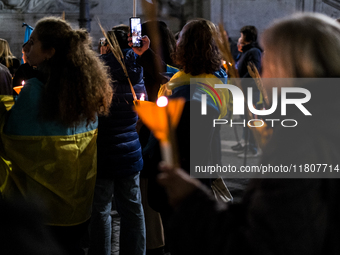 Ukrainian citizens participate in a torchlight procession in Capitol Square to commemorate the victims of the Holodomor 1932-1933, symbolizi...