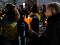 Ukrainian citizens participate in a torchlight procession in Capitol Square to commemorate the victims of the Holodomor 1932-1933, symbolizi...