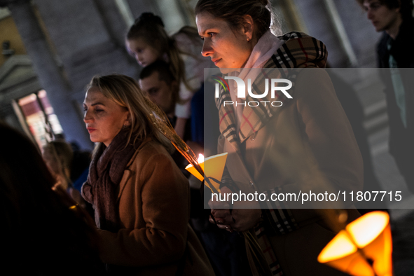 Ukrainian citizens participate in a torchlight procession in Capitol Square to commemorate the victims of the Holodomor 1932-1933, symbolizi...