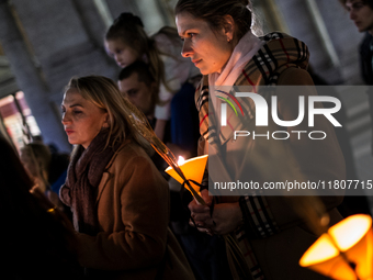 Ukrainian citizens participate in a torchlight procession in Capitol Square to commemorate the victims of the Holodomor 1932-1933, symbolizi...