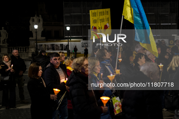 Ukrainian citizens participate in a torchlight procession in Capitol Square to commemorate the victims of the Holodomor 1932-1933, symbolizi...