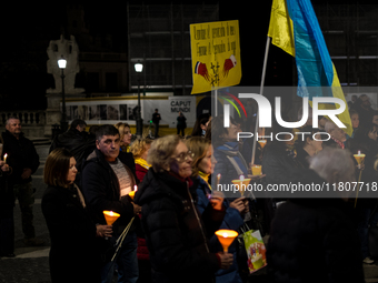 Ukrainian citizens participate in a torchlight procession in Capitol Square to commemorate the victims of the Holodomor 1932-1933, symbolizi...