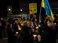 Ukrainian citizens participate in a torchlight procession in Capitol Square to commemorate the victims of the Holodomor 1932-1933, symbolizi...