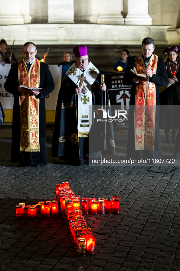 Ukrainian citizens participate in a torchlight procession in Capitol Square to commemorate the victims of the Holodomor 1932-1933, symbolizi...