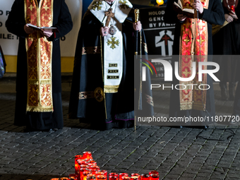 Ukrainian citizens participate in a torchlight procession in Capitol Square to commemorate the victims of the Holodomor 1932-1933, symbolizi...