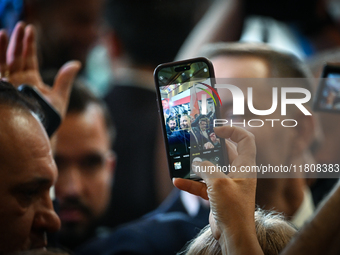 KRAKOW, POLAND - NOVEMBER 24:
One of the party supporters takes a photo with his mobile phone of Karol Nawrocki who was nominated as the Law...