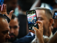 KRAKOW, POLAND - NOVEMBER 24:
One of the party supporters takes a photo with his mobile phone of Karol Nawrocki who was nominated as the Law...