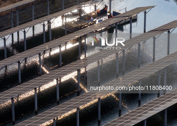 Workers set up solar panels at the construction site of Baima Lake Farm's fishery-solar hybrid project, with a total investment of 300 milli...