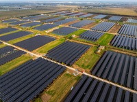 Workers set up solar panels at the construction site of Baima Lake Farm's fishery-solar hybrid project, with a total investment of 300 milli...