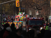 Participants take part in the annual Santa Claus Parade in Toronto, Ontario, Canada, on November 24, 2024. Thousands of people line the stre...