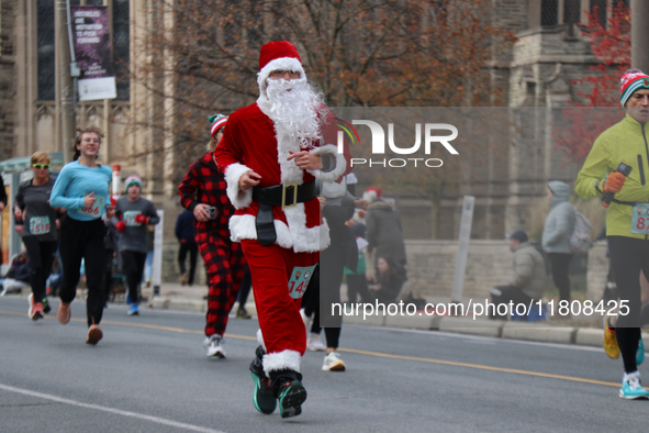 Participants take part in the annual Santa Claus Parade in Toronto, Ontario, Canada, on November 24, 2024. Thousands of people line the stre...