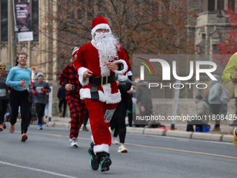 Participants take part in the annual Santa Claus Parade in Toronto, Ontario, Canada, on November 24, 2024. Thousands of people line the stre...