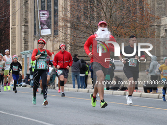 Participants take part in the annual Santa Claus Parade in Toronto, Ontario, Canada, on November 24, 2024. Thousands of people line the stre...