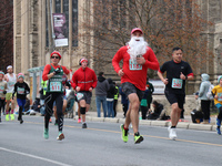 Participants take part in the annual Santa Claus Parade in Toronto, Ontario, Canada, on November 24, 2024. Thousands of people line the stre...