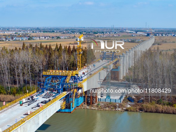 Workers work on the Nanjing-Huai'an Intercity Railway in Huai'an, Jiangsu province, China, on November 24, 2024. 