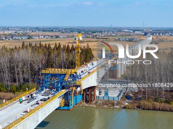 Workers work on the Nanjing-Huai'an Intercity Railway in Huai'an, Jiangsu province, China, on November 24, 2024. (