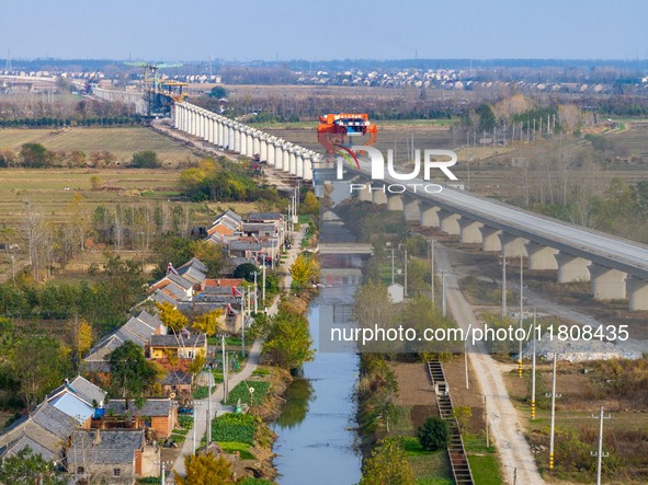 Workers work on the Nanjing-Huai'an Intercity Railway in Huai'an, Jiangsu province, China, on November 24, 2024. 