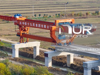 Workers work on the Nanjing-Huai'an Intercity Railway in Huai'an, Jiangsu province, China, on November 24, 2024. (