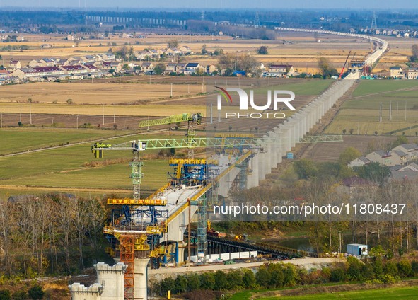 Workers work on the Nanjing-Huai'an Intercity Railway in Huai'an, Jiangsu province, China, on November 24, 2024. 