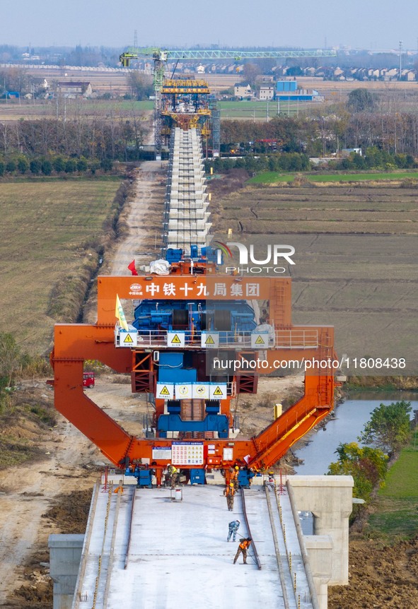 Workers work on the Nanjing-Huai'an Intercity Railway in Huai'an, Jiangsu province, China, on November 24, 2024. 