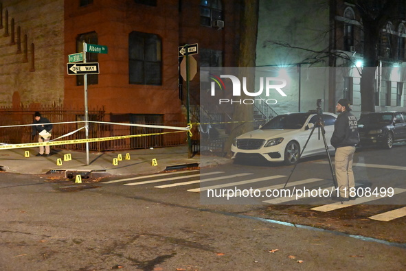 The NYPD Crime Scene Unit investigates the scene and places evidence markers where one man is killed and another man is injured in a shootin...