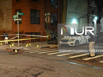 The NYPD Crime Scene Unit investigates the scene and places evidence markers where one man is killed and another man is injured in a shootin...