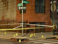 The NYPD Crime Scene Unit investigates the scene and places evidence markers where one man is killed and another man is injured in a shootin...