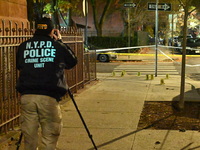 The NYPD Crime Scene Unit investigates the scene and places evidence markers where one man is killed and another man is injured in a shootin...