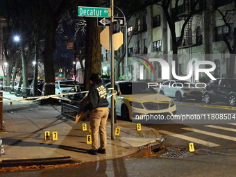 The NYPD Crime Scene Unit investigates the scene and places evidence markers where one man is killed and another man is injured in a shootin...