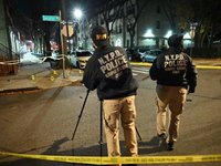 The NYPD Crime Scene Unit investigates the scene and places evidence markers where one man is killed and another man is injured in a shootin...