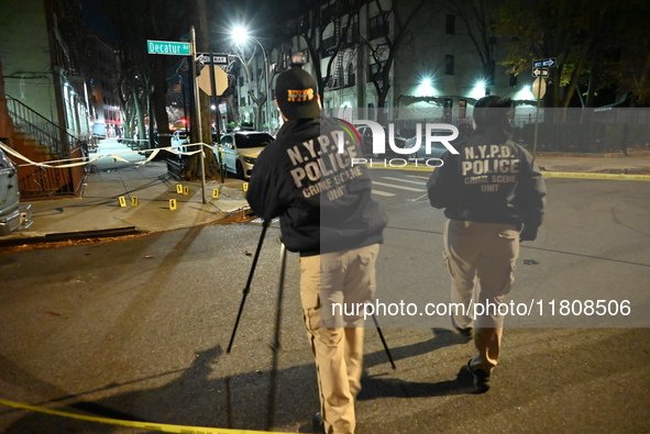 The NYPD Crime Scene Unit investigates the scene and places evidence markers where one man is killed and another man is injured in a shootin...