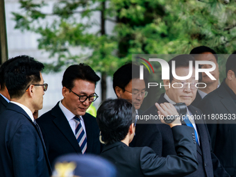 Lee Jae-myung (center), leader of the Democratic Party of Korea, leaves the Seoul Central District Court in Seocho-gu, Seoul, on November 25...